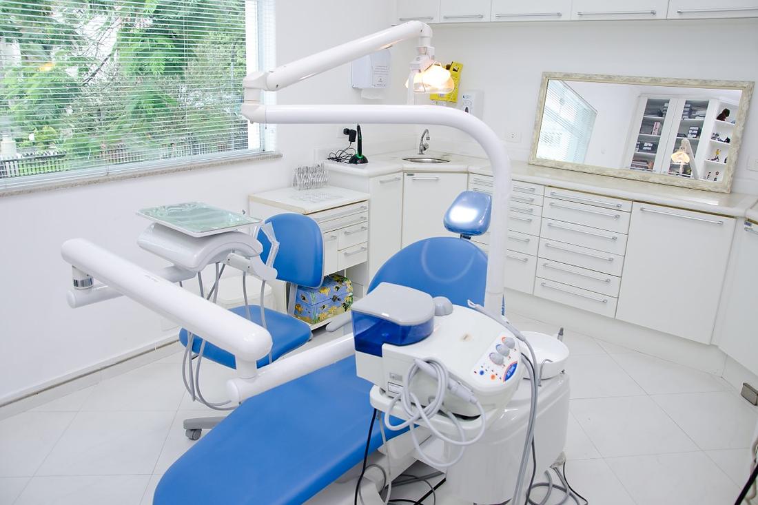 Consultório odontológico com cadeira e equipamento